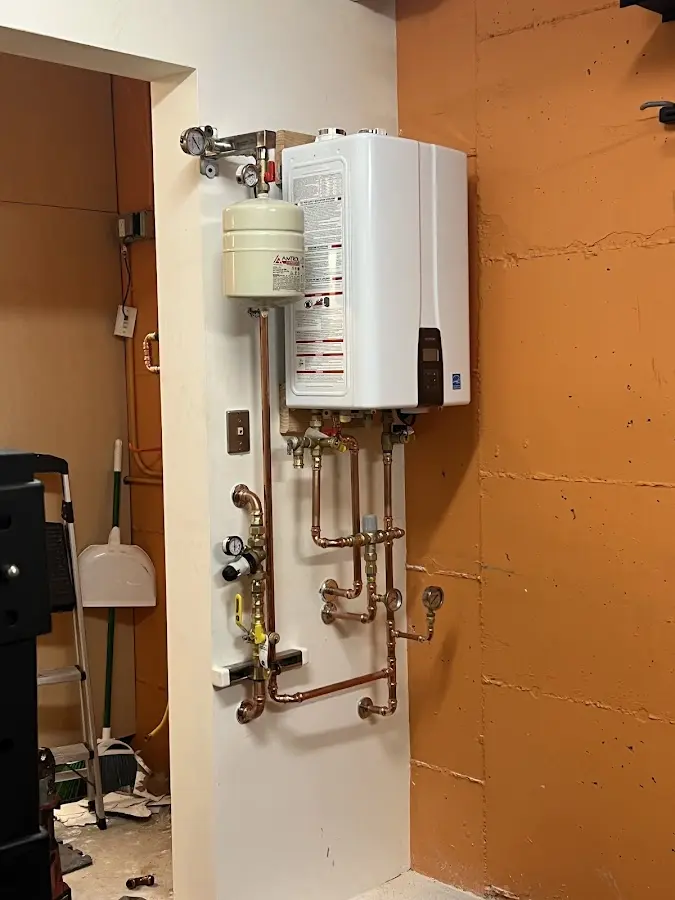 Plumbing technician inspecting water heater connections in Cypress Lake